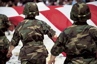 Soldiers with American Flag in Parade --- Image by © Royalty-Free/Corbis